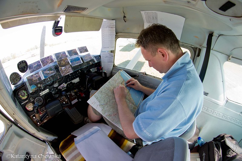 View inside cockpit as pilot checks route for World Air Rally Flying championships