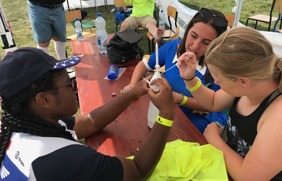 US Juniors work together during an epic rebuild of Charise Houston's Saturn 1B in Poland, 2018. US Juniors space modelling Poland, 2018.